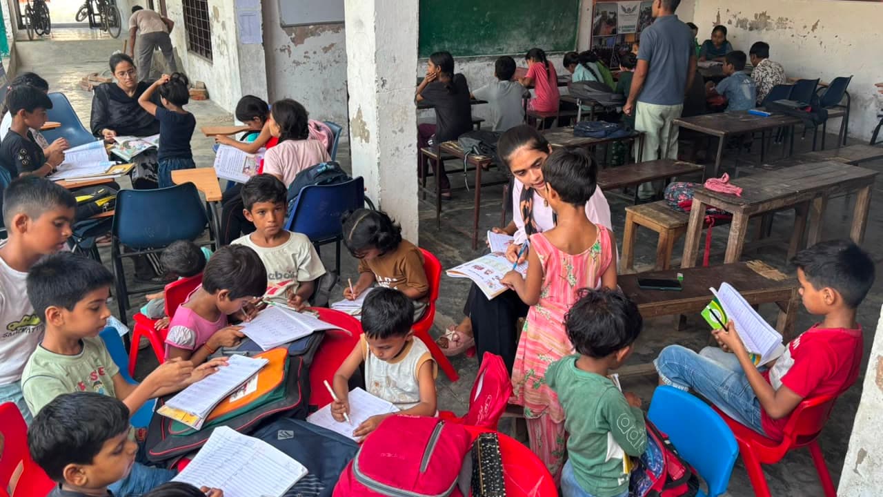 Children reading workbooks together at a Dreamwings learning centre